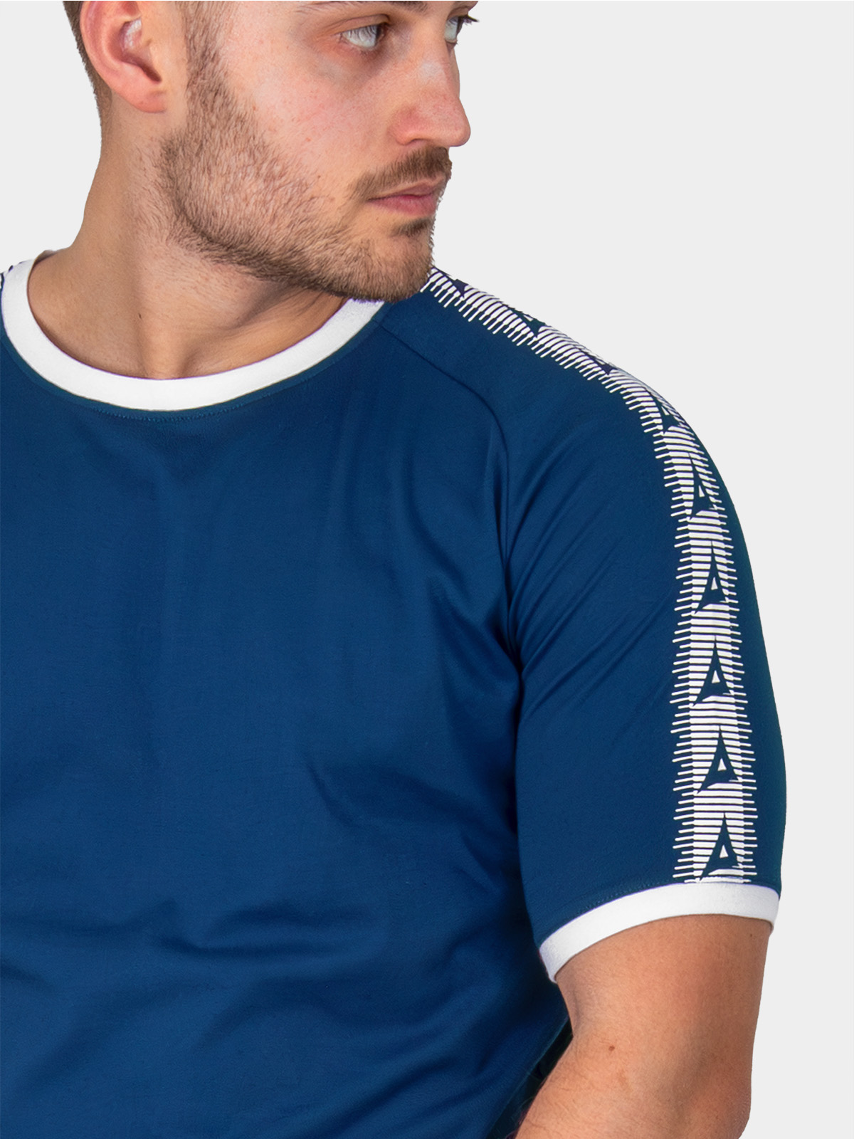 close-up of avec heritage 'a' logo taping on the avec evolve navy t-shirt