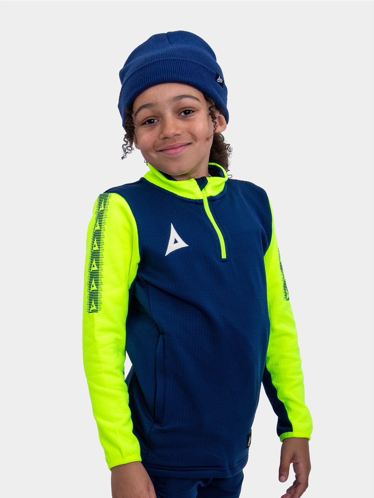 	a boy wearing a navy turn up beanie and a navy and neon yellow overlay