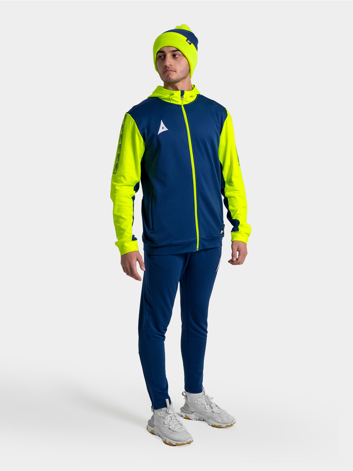 person in navy blue and neon yellow athletic outfit