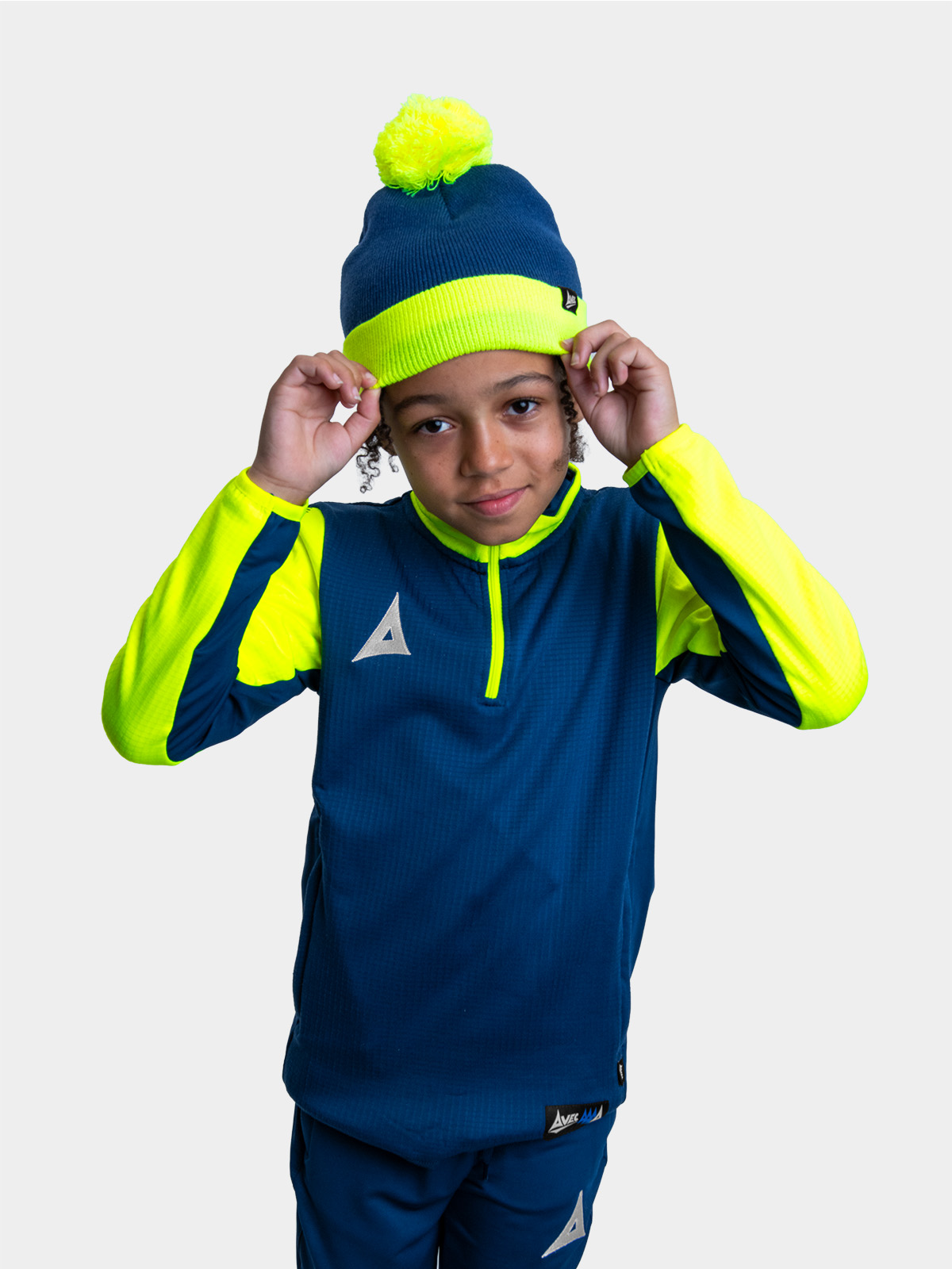 	child wearing navy blue and neon yellow athletic outfit