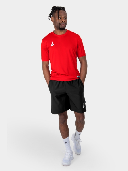 	man wearing a red training t-shirt and black woven shorts