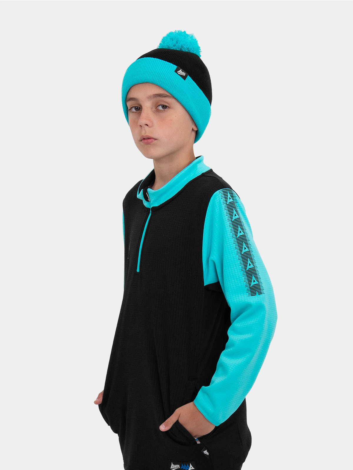 a junior is wearing a black and light blue bobble hat, with a matching overlay jumper.