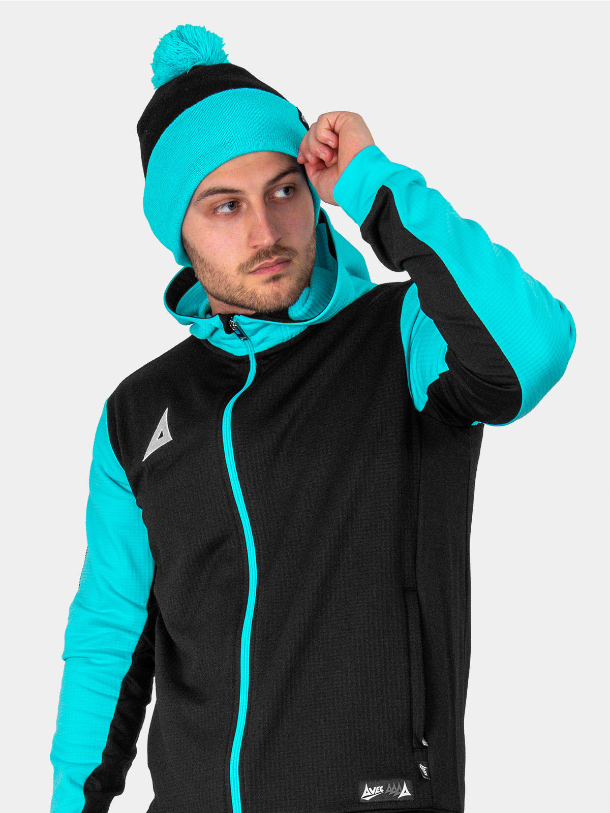 a man is wearing a black and blue bobble hat