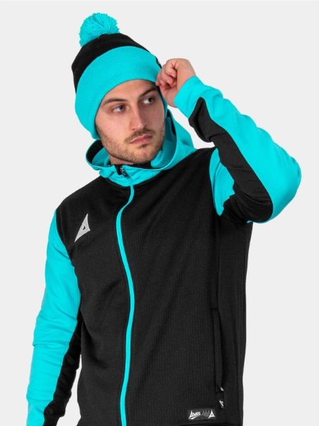 A man is wearing a Black and Blue Bobble Hat