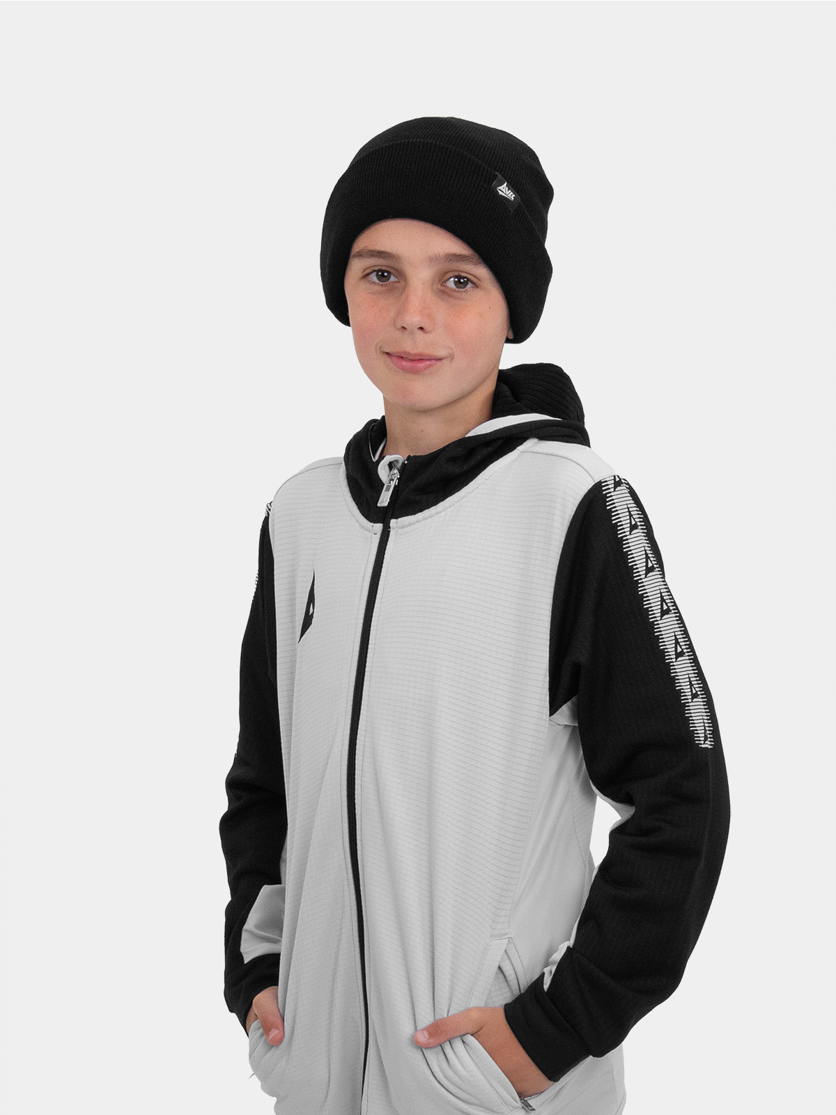 a young boy wearing a black beanie hat with a grey and black track hoodie