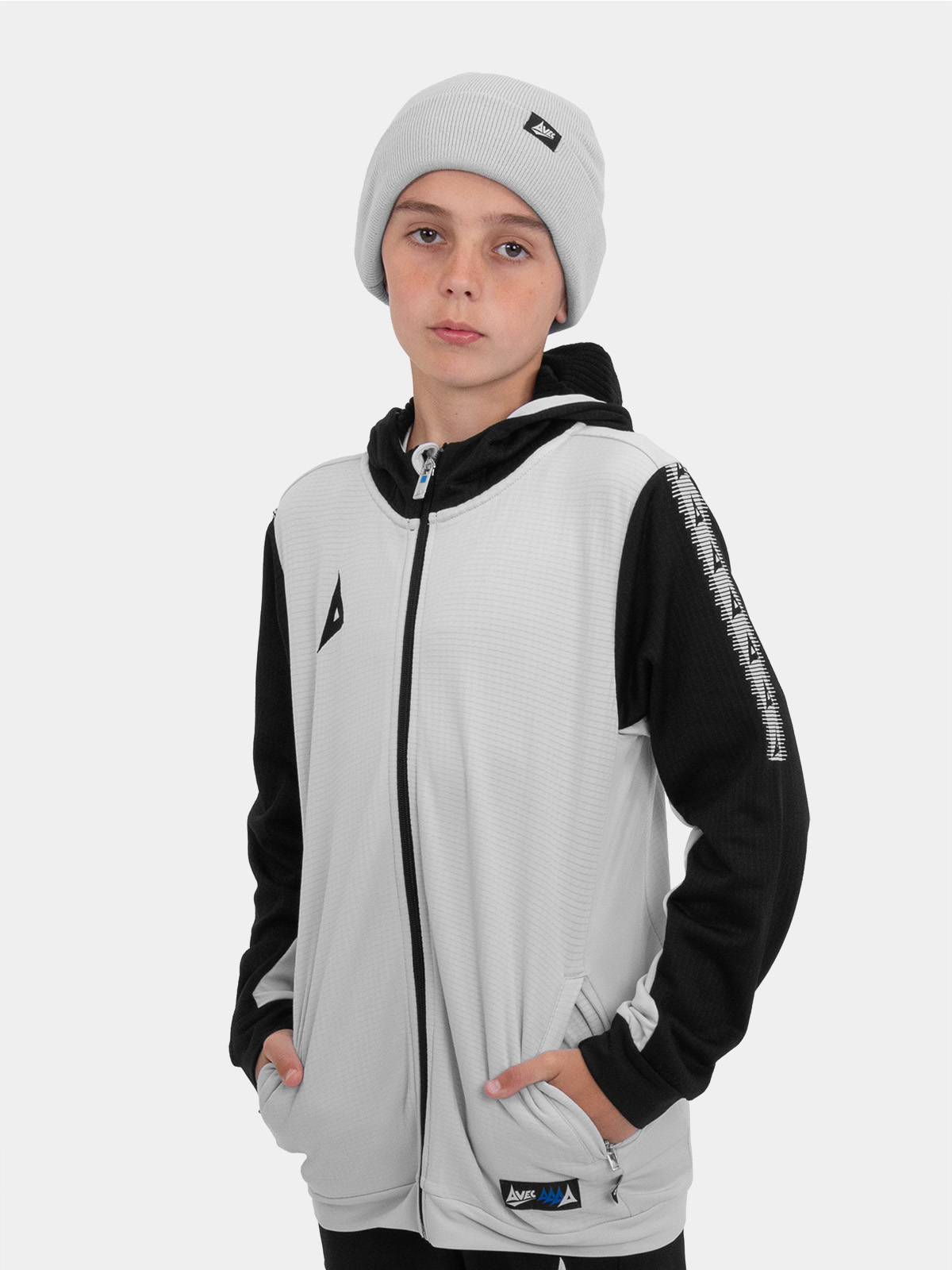 a junior model wearing a matching grey beanie and overlay with black accents