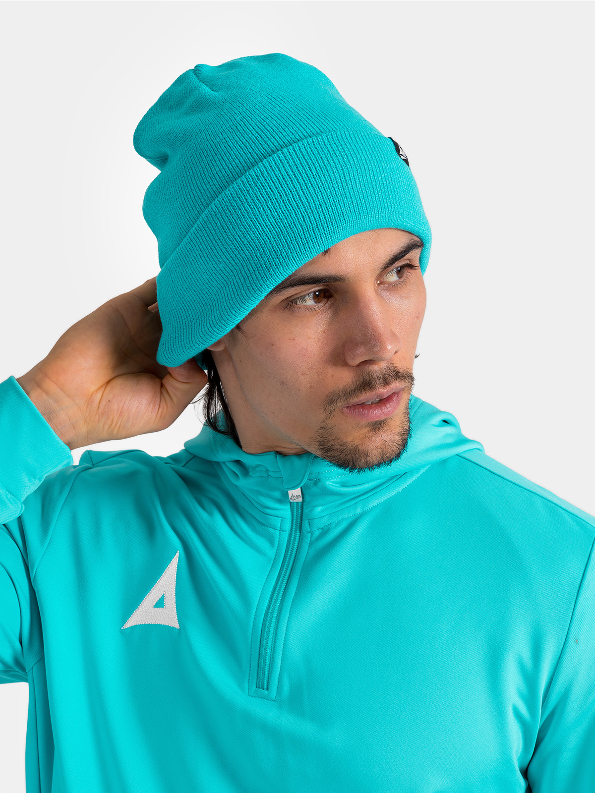 	this man is wearing a bright blue hat with a turn up