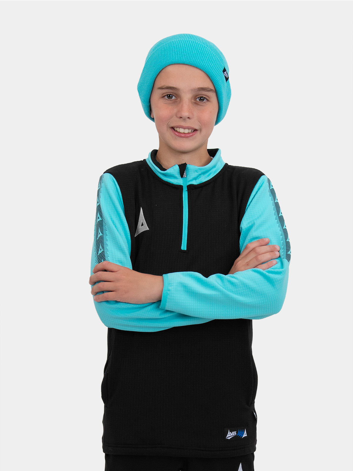 this boy is keeping warm with the blue turn up hat