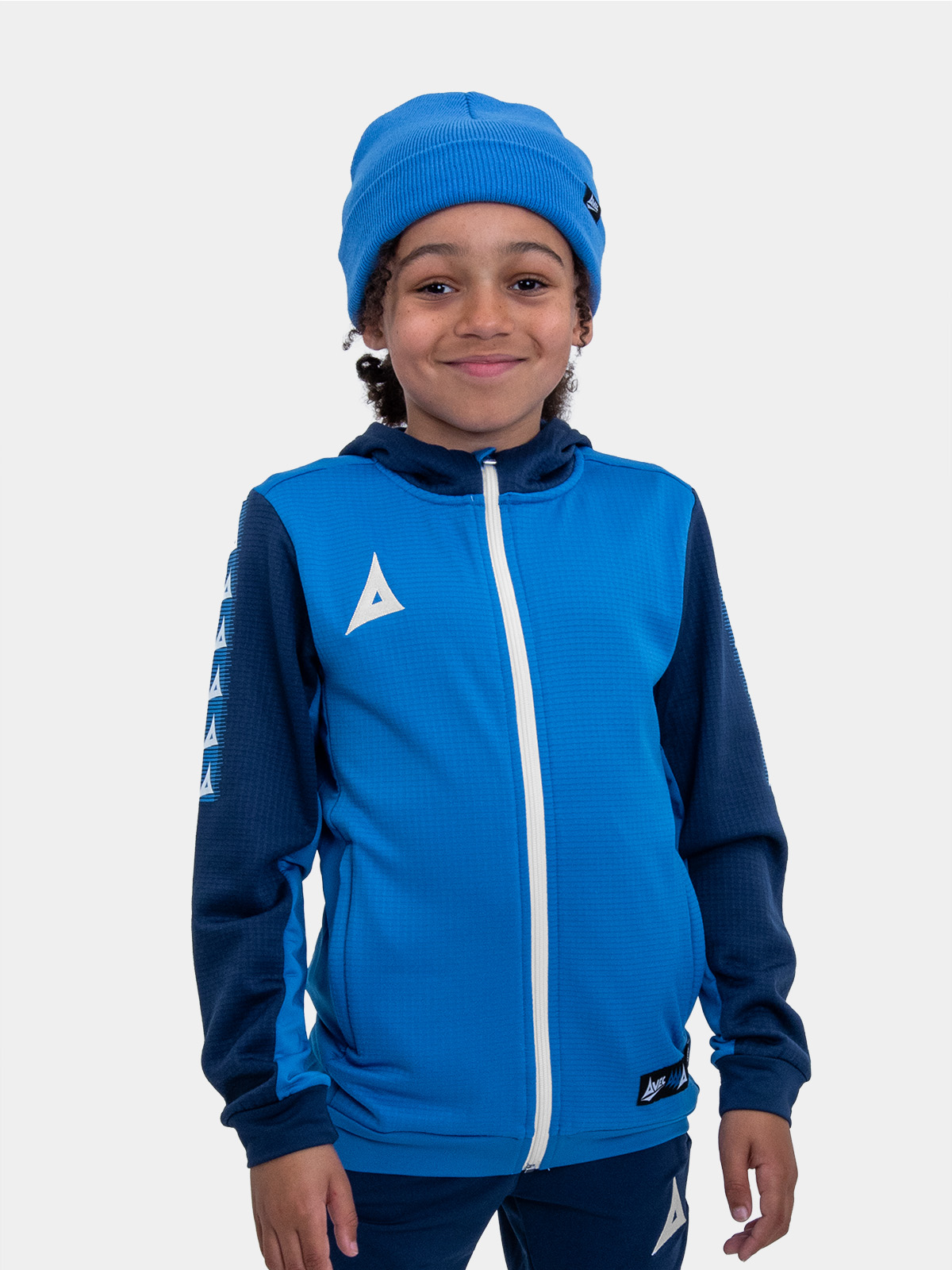 	a child keeping warm wearing a royal blue turn up bronx beanie