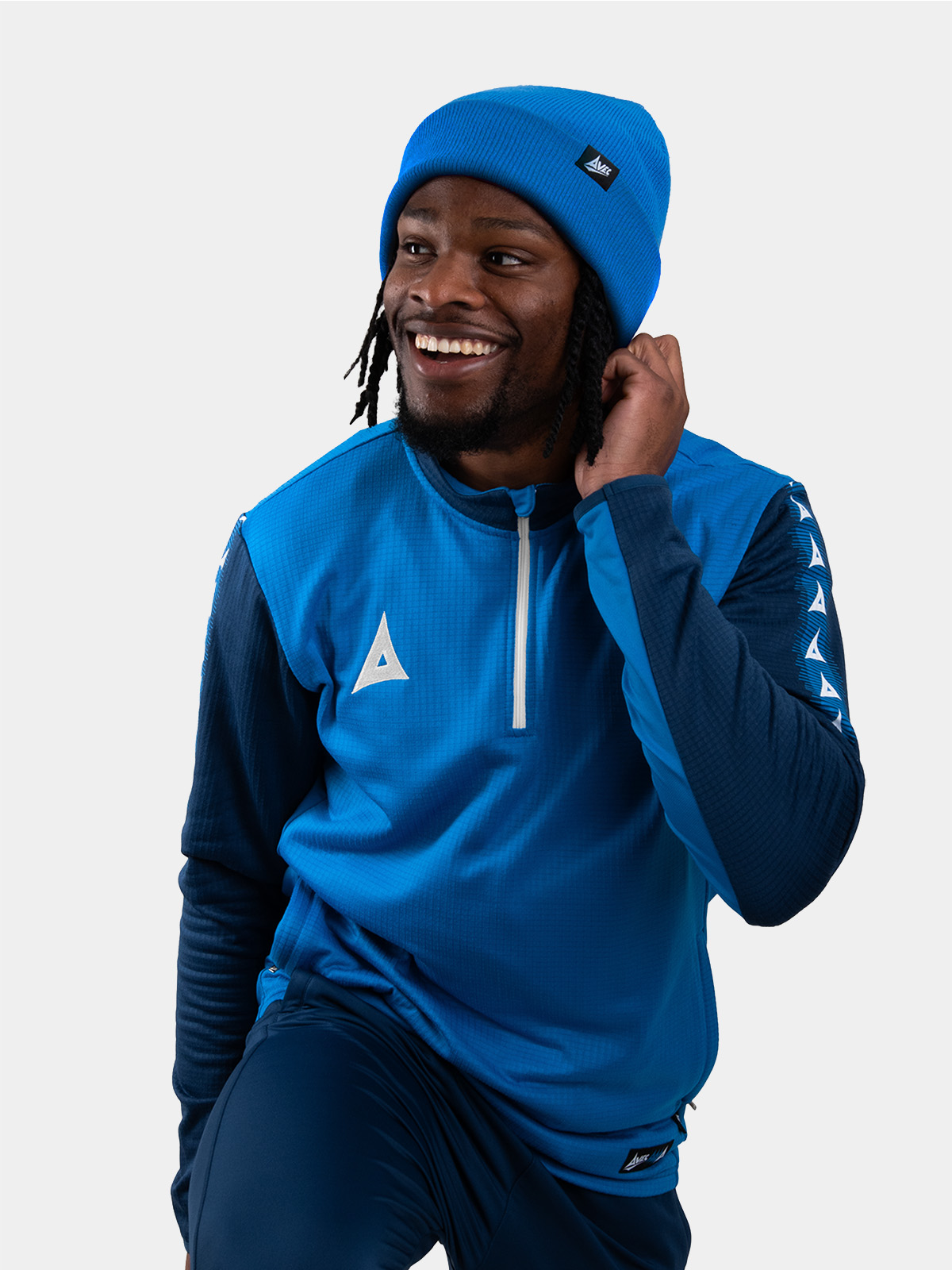 	a man keeping warm wearing a royal blue turn up bronx beanie