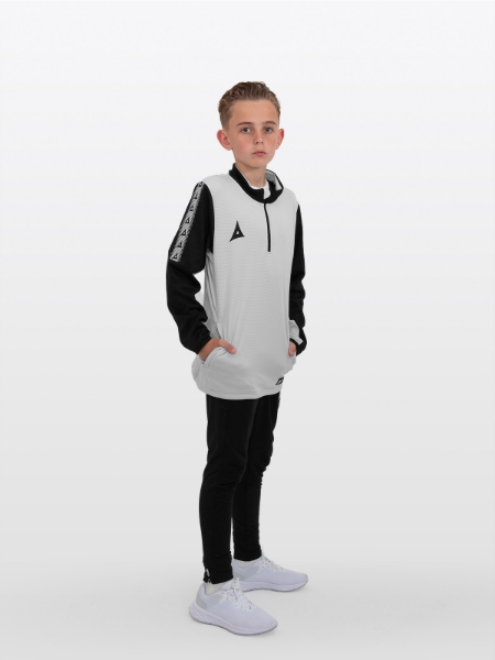 The child in this image is wearing a light grey sweat top in a junior size alongside black joggers.