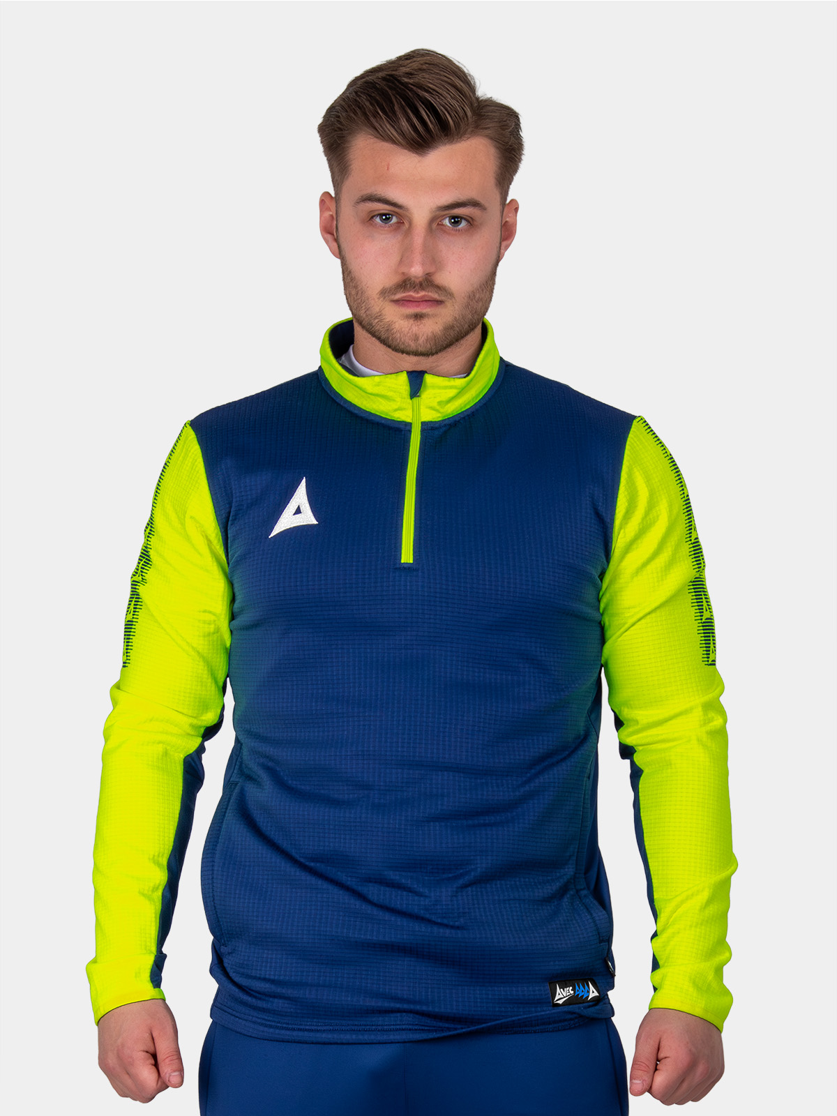 a man wearing a navy jumper with bright yellow sleeves and collar.