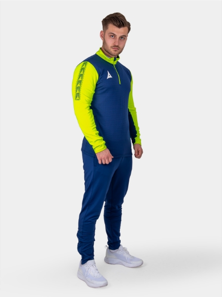 A man is wearing a navy sweat top with florescent yellow sleeves
