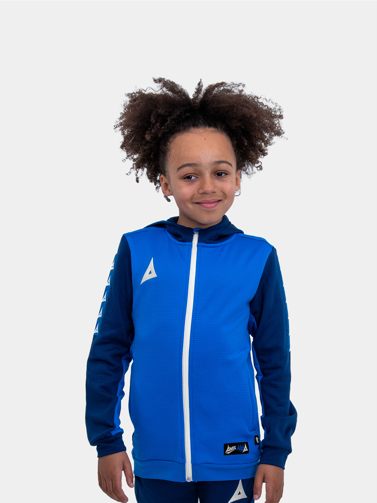 	with his hands on his hips, this child is wearing a royal blue hoody.