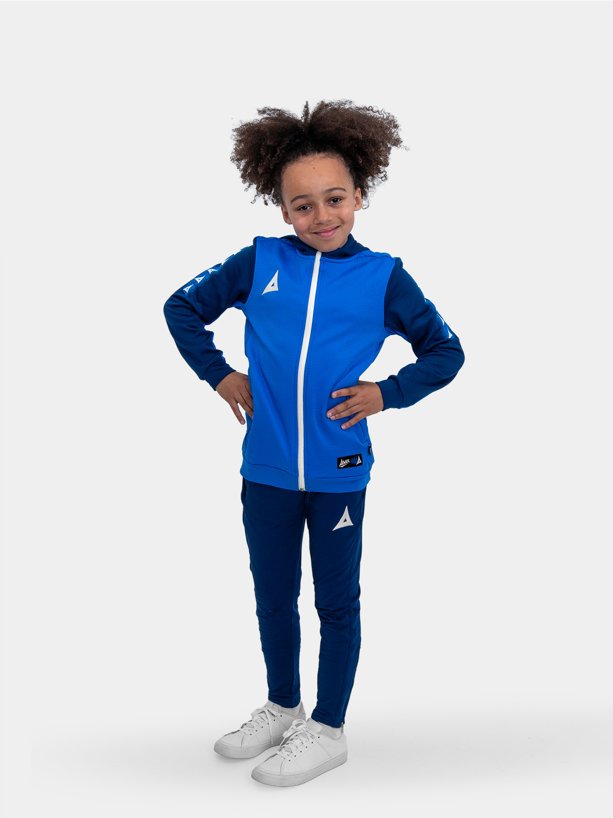 	a boy is wearing a kids hoody in blue with blue jogging bottoms