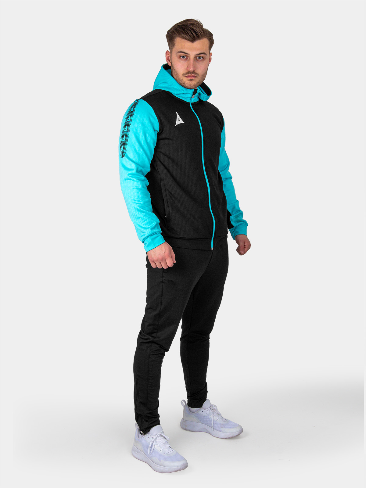 a man is wearing a a black hoody and joggers