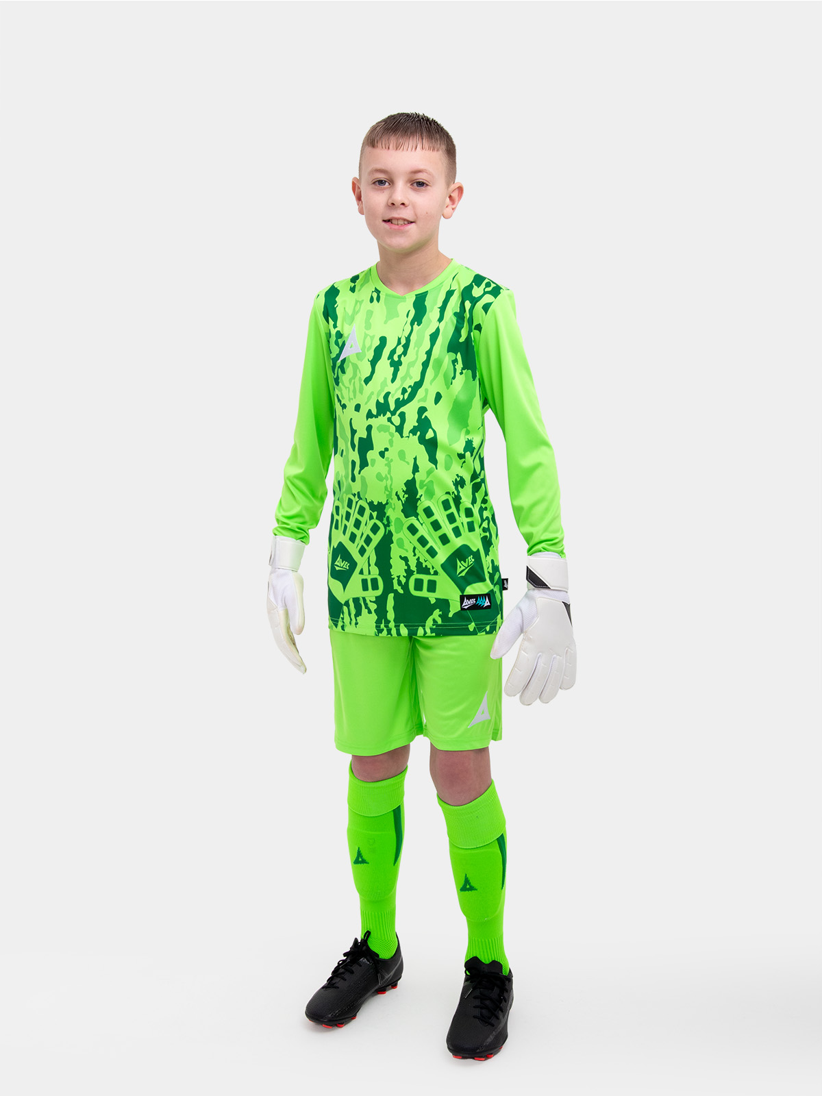	a child is wearing a neon green goalkeeper football shirt. the football shirt has a camo pattern