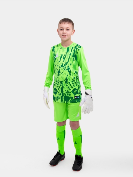 	A child is wearing a neon green goalkeeper Football Shirt. The football shirt has a camo pattern