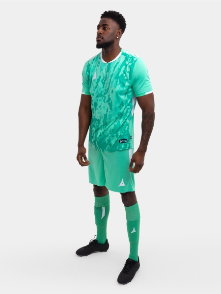 	A man wearing an all mint green / hyper green Football Kit