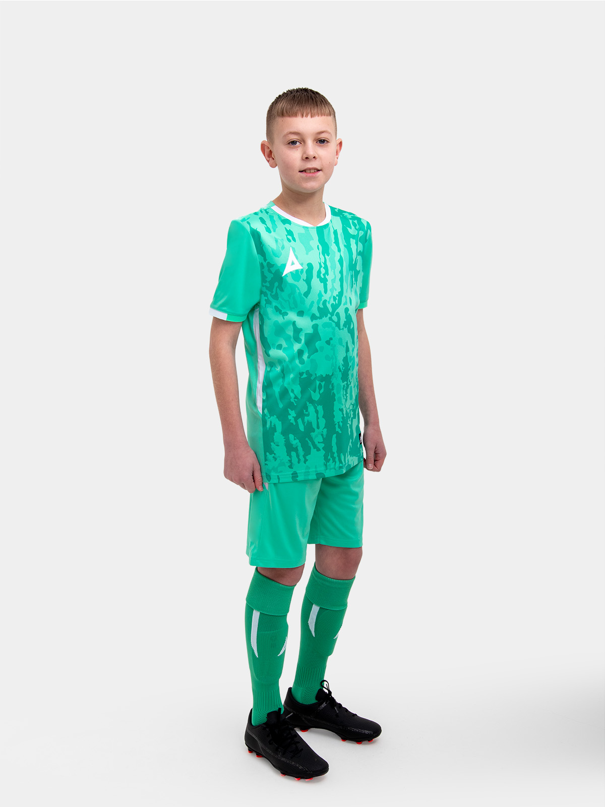 a boy is stood with his hands by his side with mint green / hyper green shorts on matching his t-shirt.