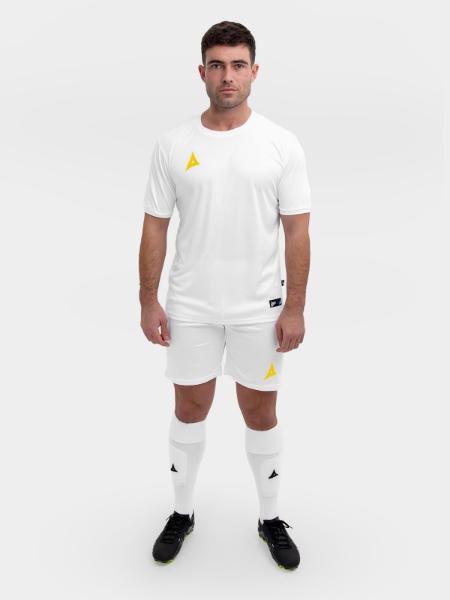 	A complete white football kit with yellow logos is being worn by this man.