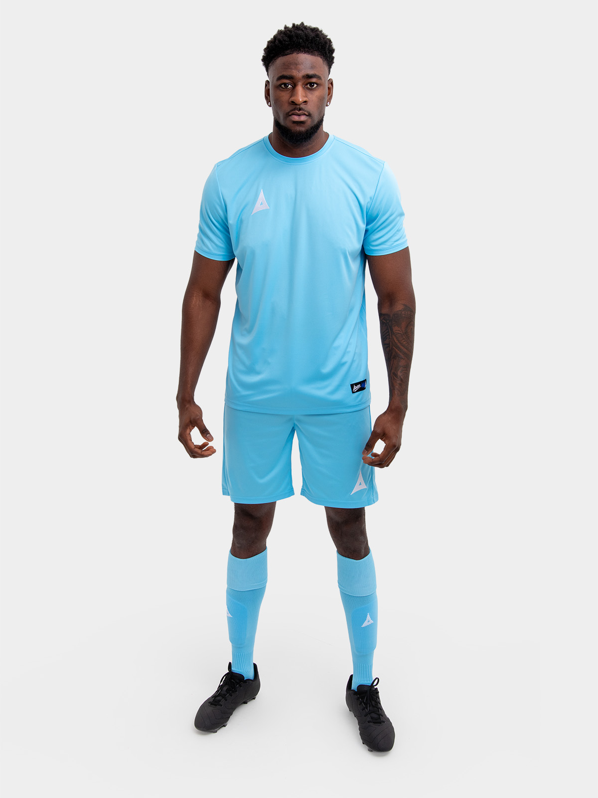 	an adults football kit in sky and matching sky blue shorts and socks
