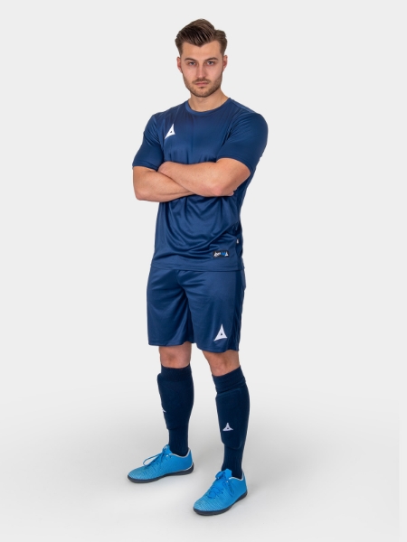 	A man wearing an all Navy Blue Football Kit