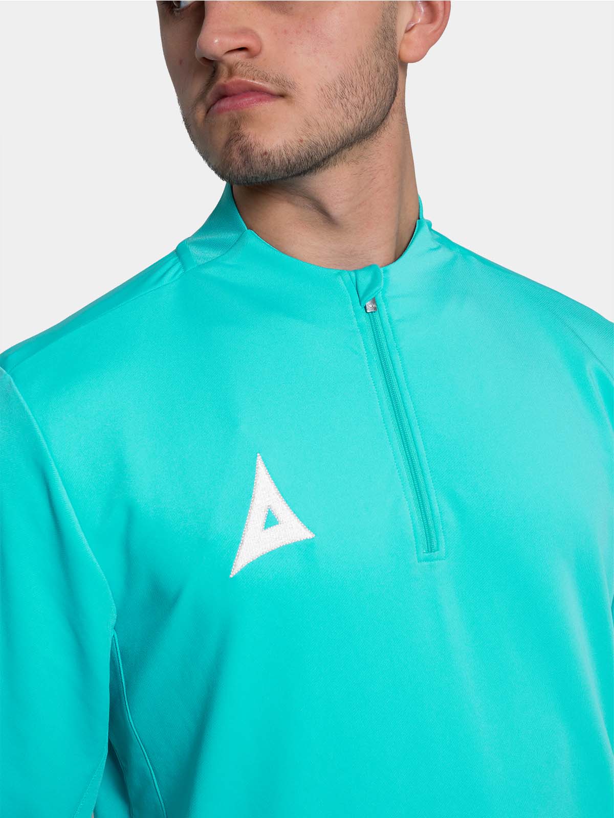 close-up shot of the 1/4 zip fastened, showing the clean finish and premium embroidery on the chest.