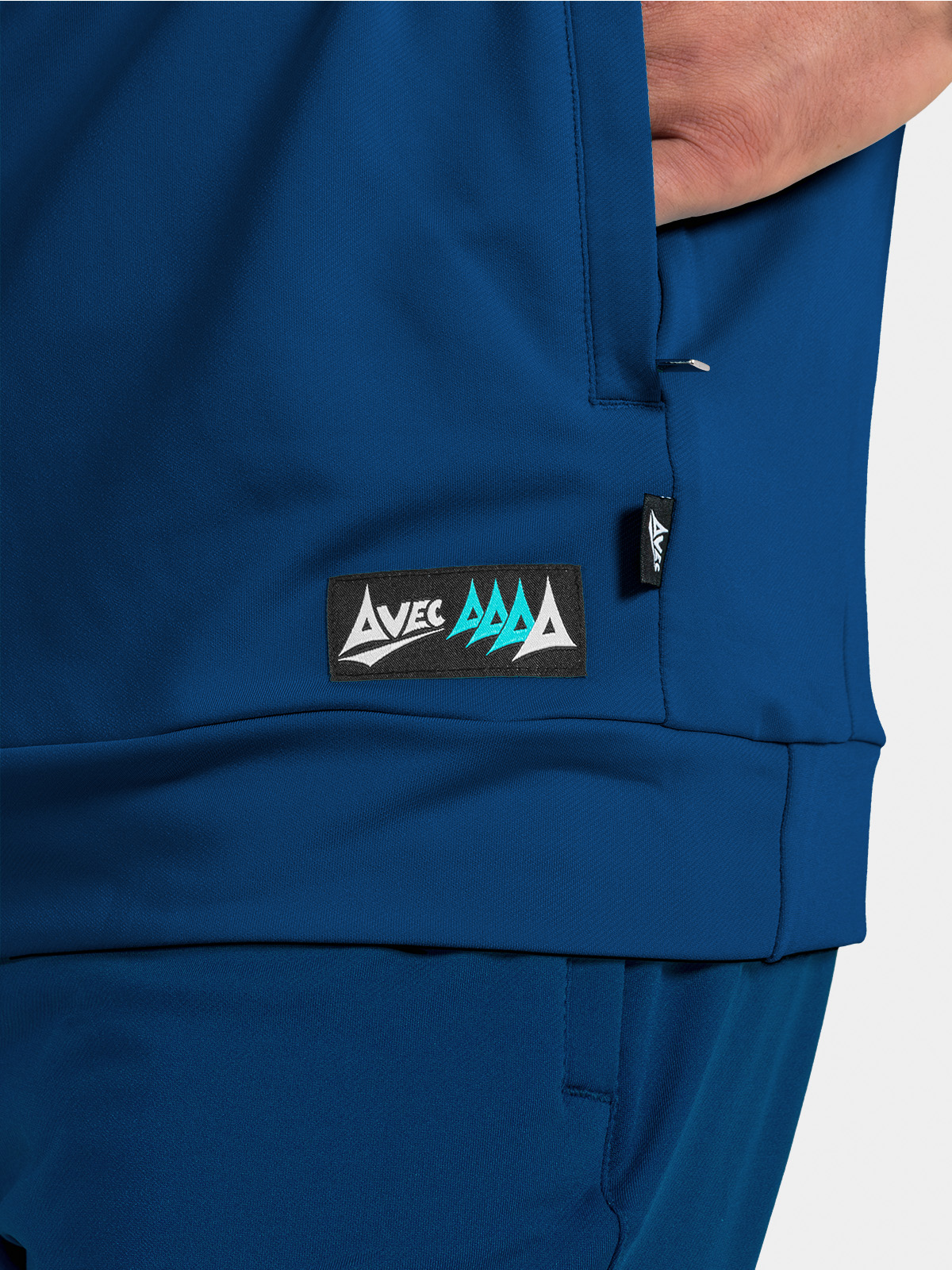 	side hem detail of the navy hoody, highlighting the zipped pocket and official product authenticity tag.
