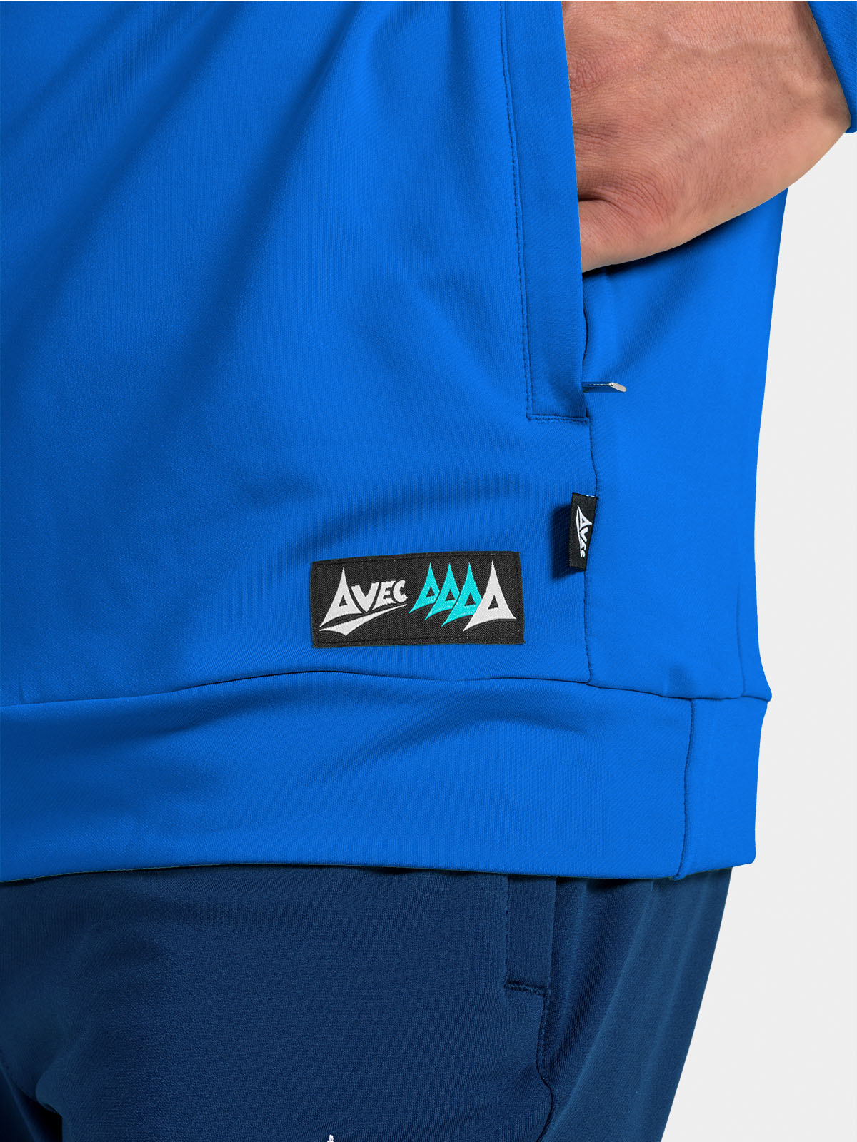 	detail of the royal blue hem, featuring the secure storage pocket and woven avec sport authenticity label