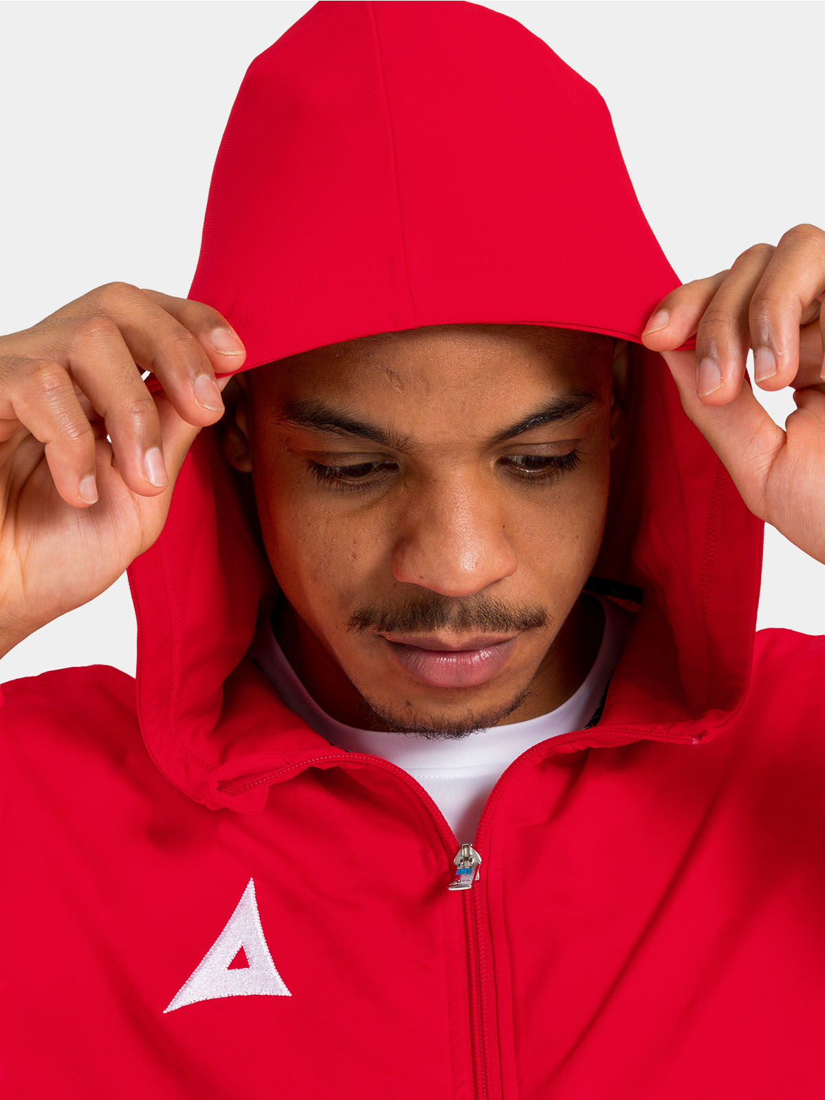 	detailed view of the red technical hood, built for warmth and breathability on the training pitch
