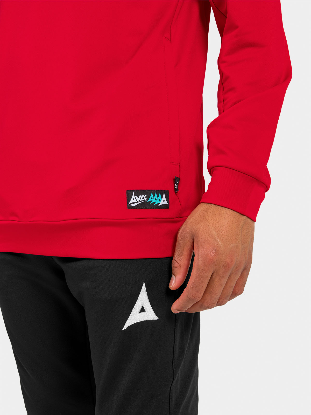 	lower shot of the red hoody hem, displaying the secure zipped pocket and woven authentic id label.