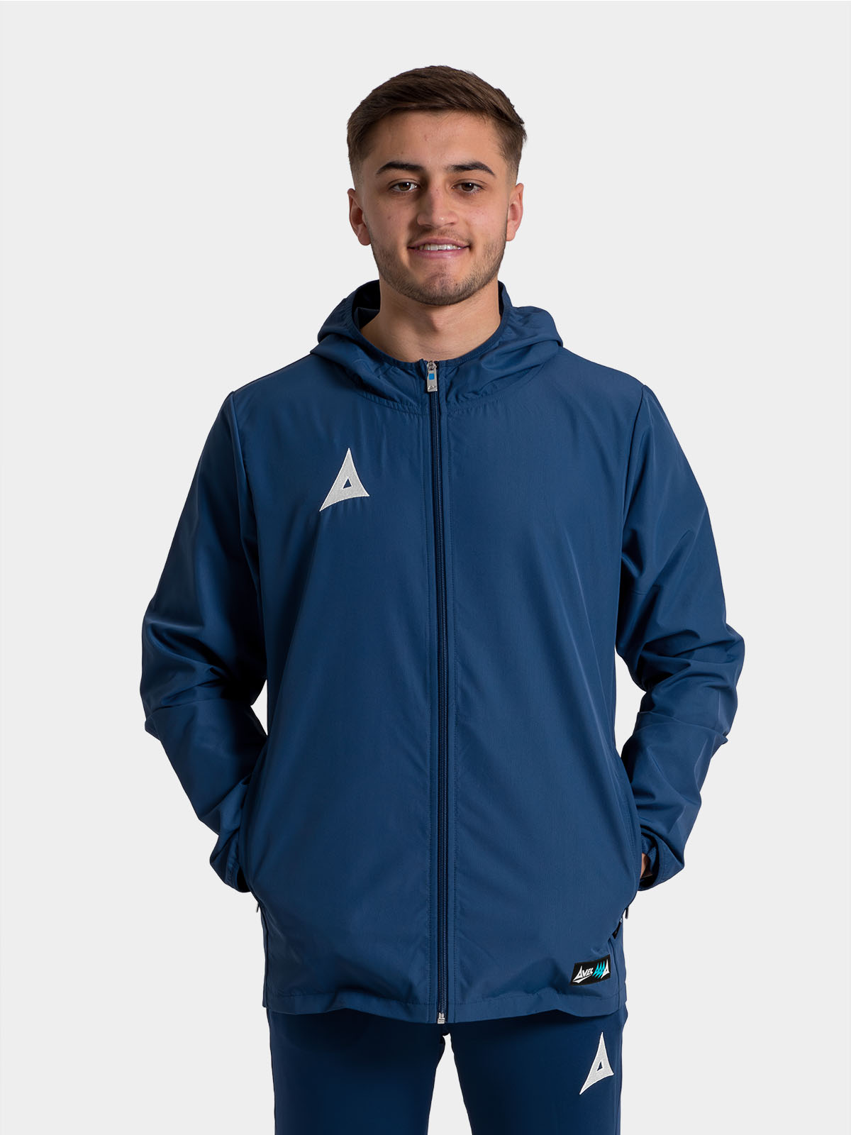 	adult model wearing the navy focus 2 shell jacket, showcasing the secure full-zip fastening
