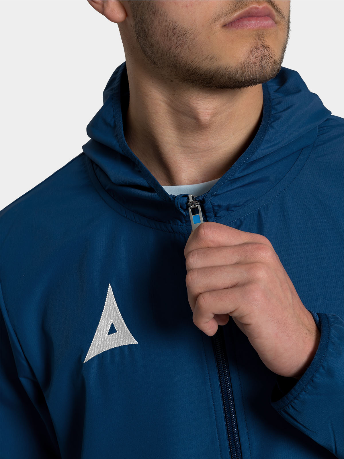 close-up of the robust front zip on the navy focus 2 football rain jacket, ensuring a secure and warm fit.
