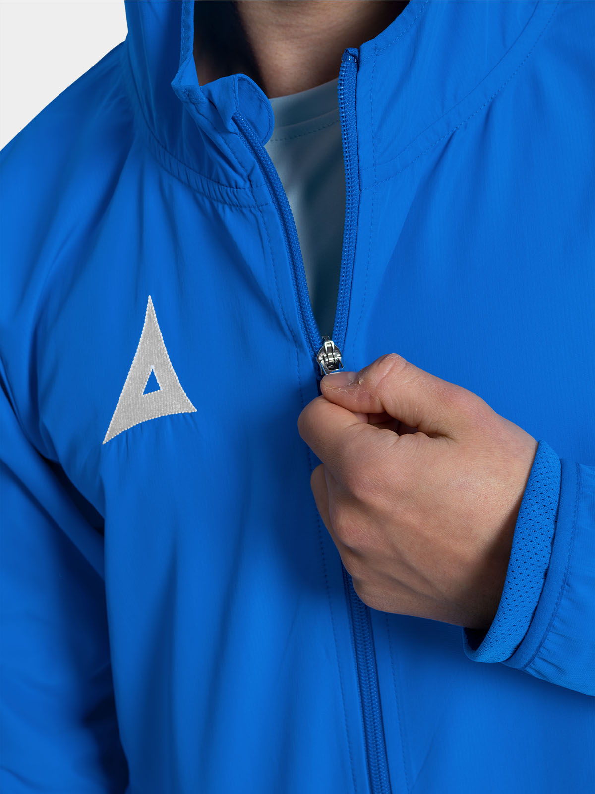 close-up of the high-quality zipper on the royal blue football training jacket, built for frequent club use.