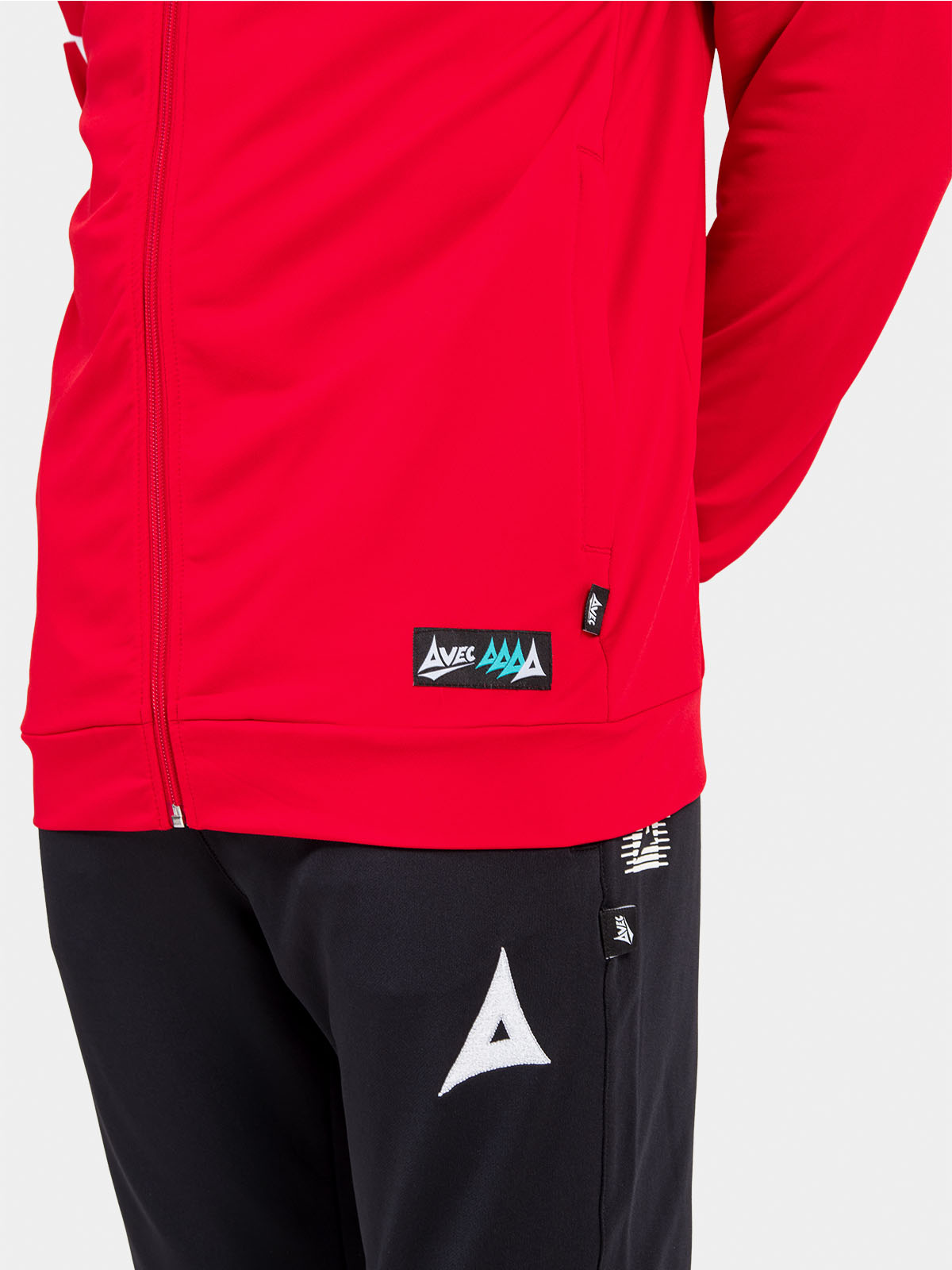 close-up of the red hoody hem, displaying the functional side pocket and official authenticity id label.