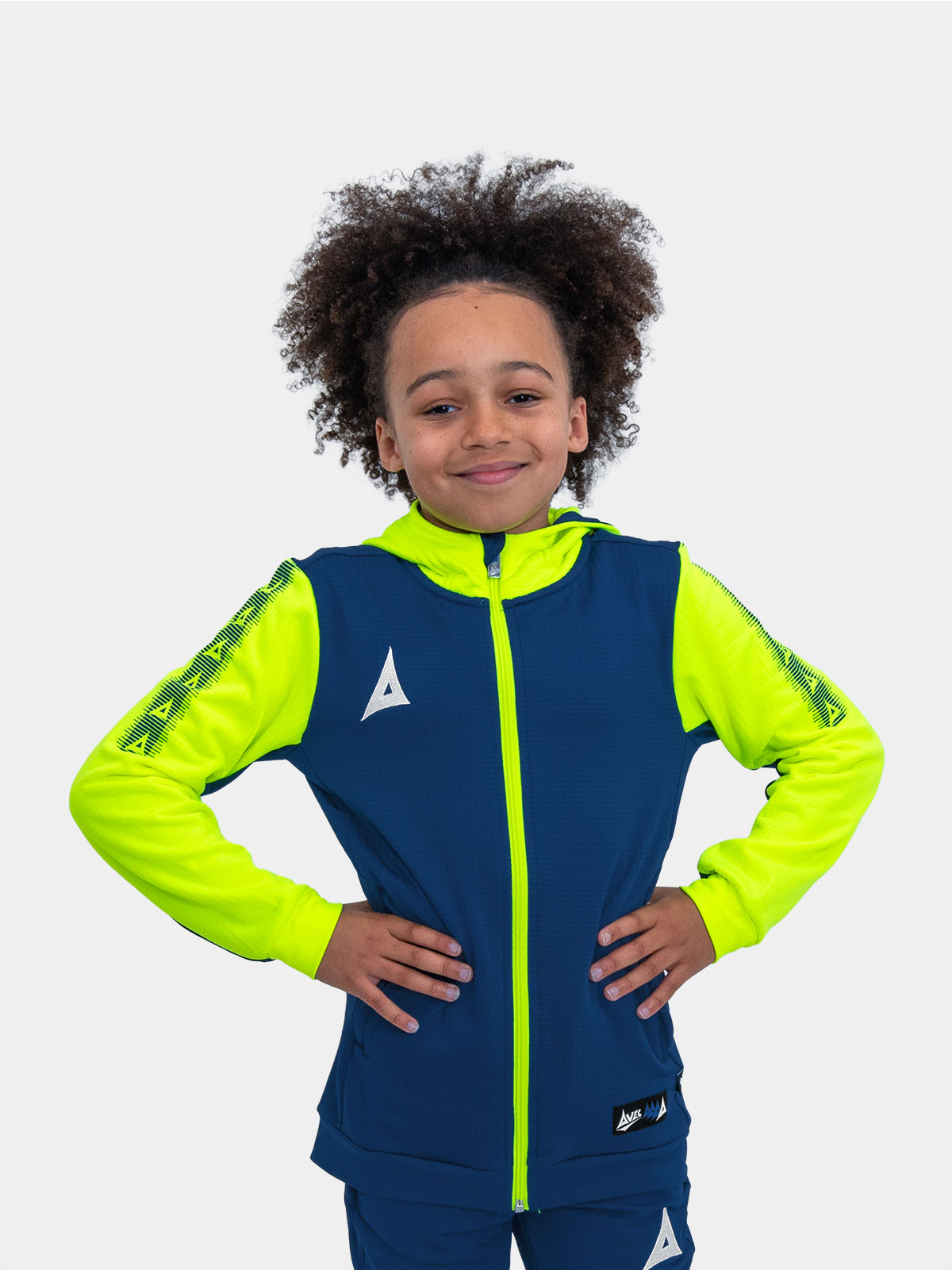 	a young boy in a vibrant neon yellow and blue hoody, radiating energy and style.