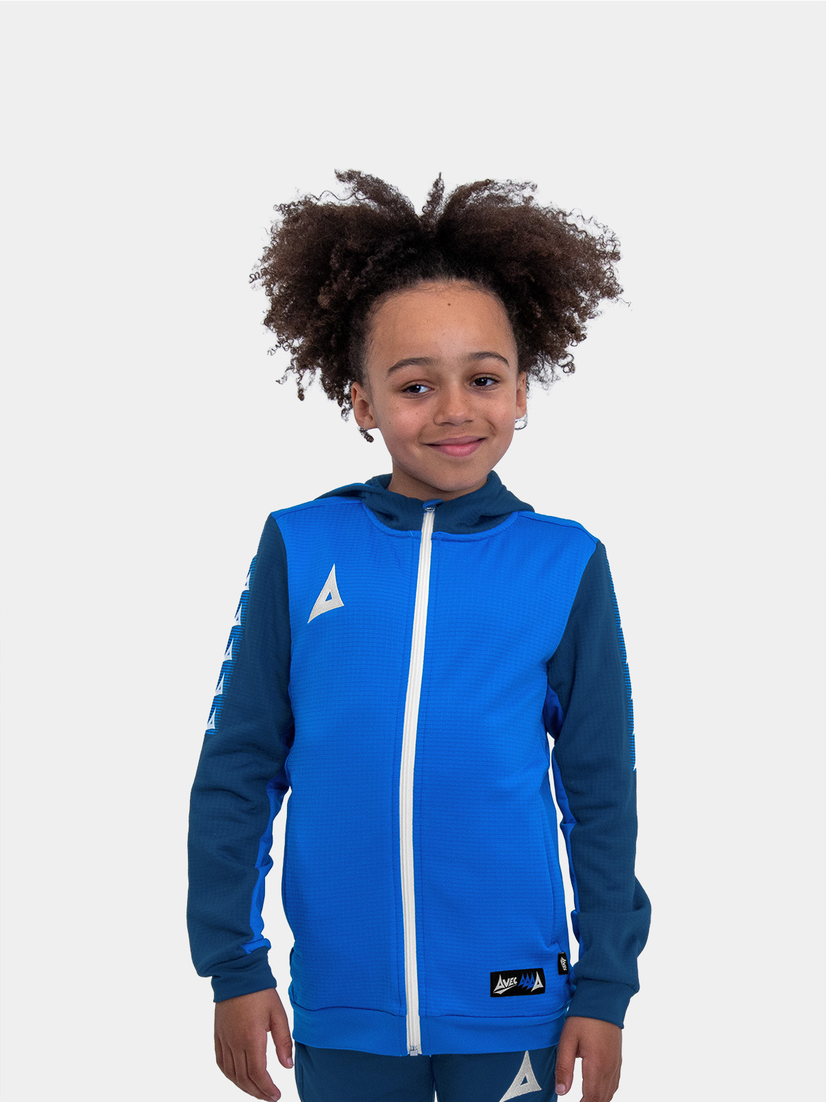 	with his hands on his hips, this child is wearing a royal blue hoody.