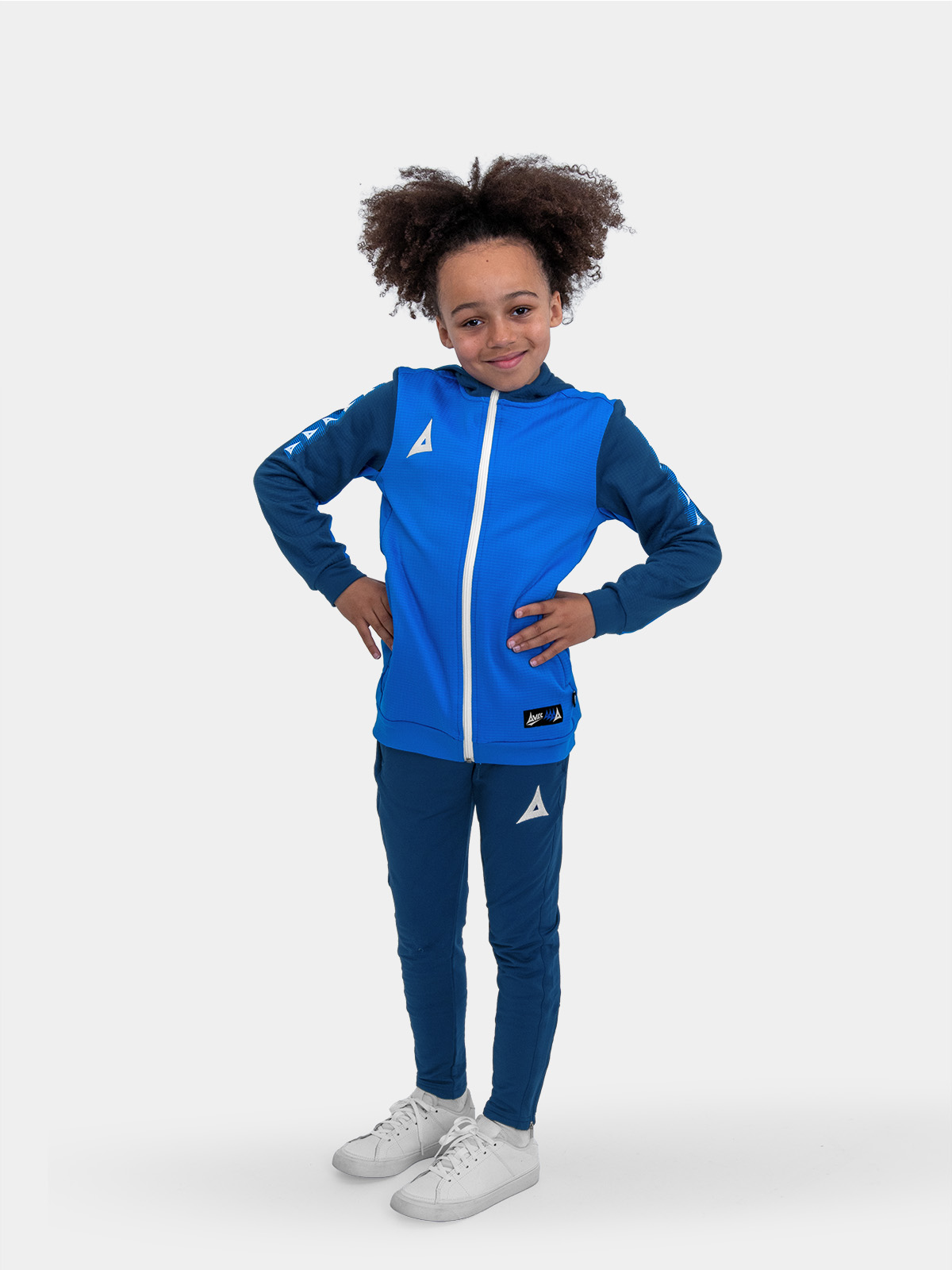 	a boy is wearing a kids hoody in blue with blue jogging bottoms