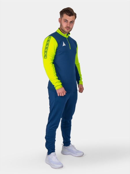 	A man is wearing a navy sweat top with florescent yellow sleeves