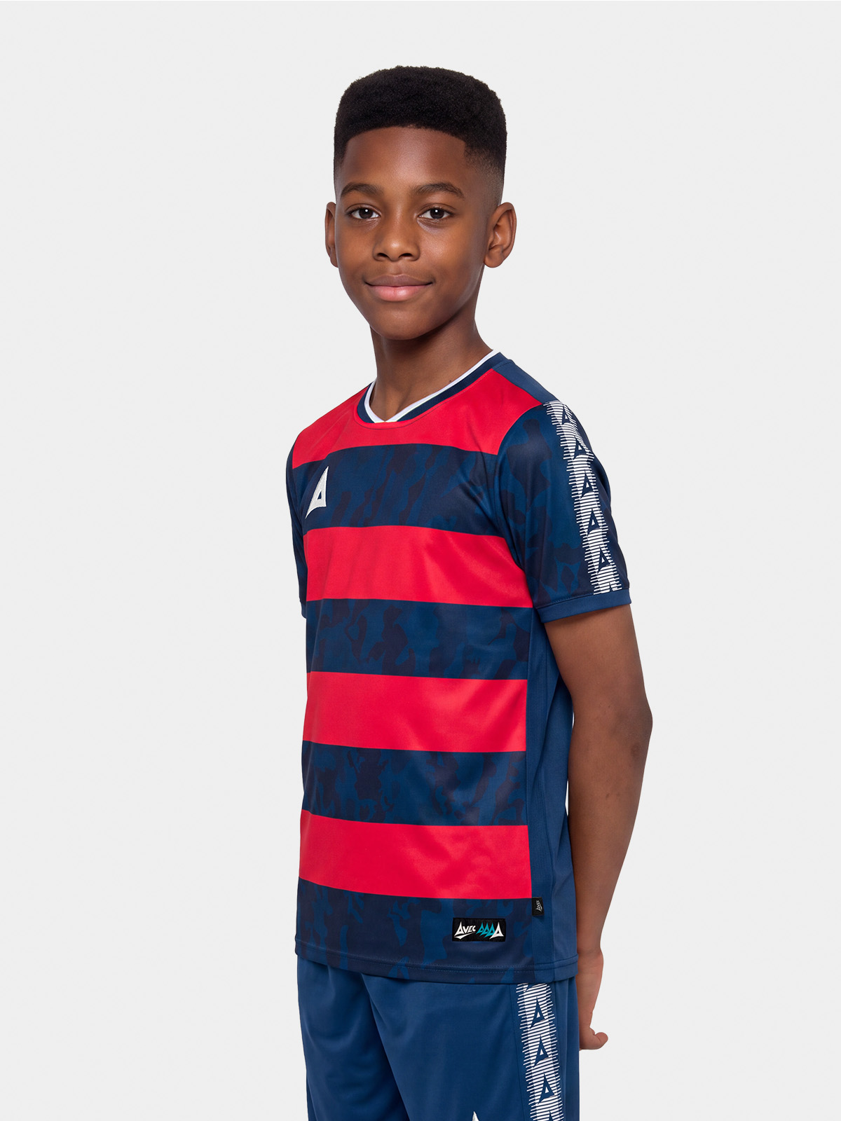 	junior model showcasing the navy and red pro intent hoop jersey, highlighting the modern textured design and pro-fit.