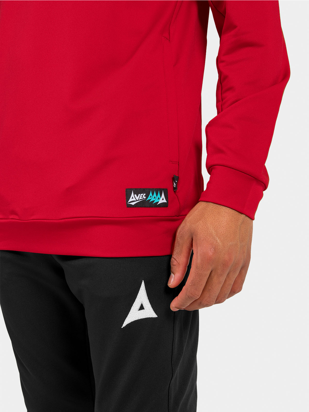 	lower shot of the red hoody hem, displaying the secure zipped pocket and woven authentic id label.