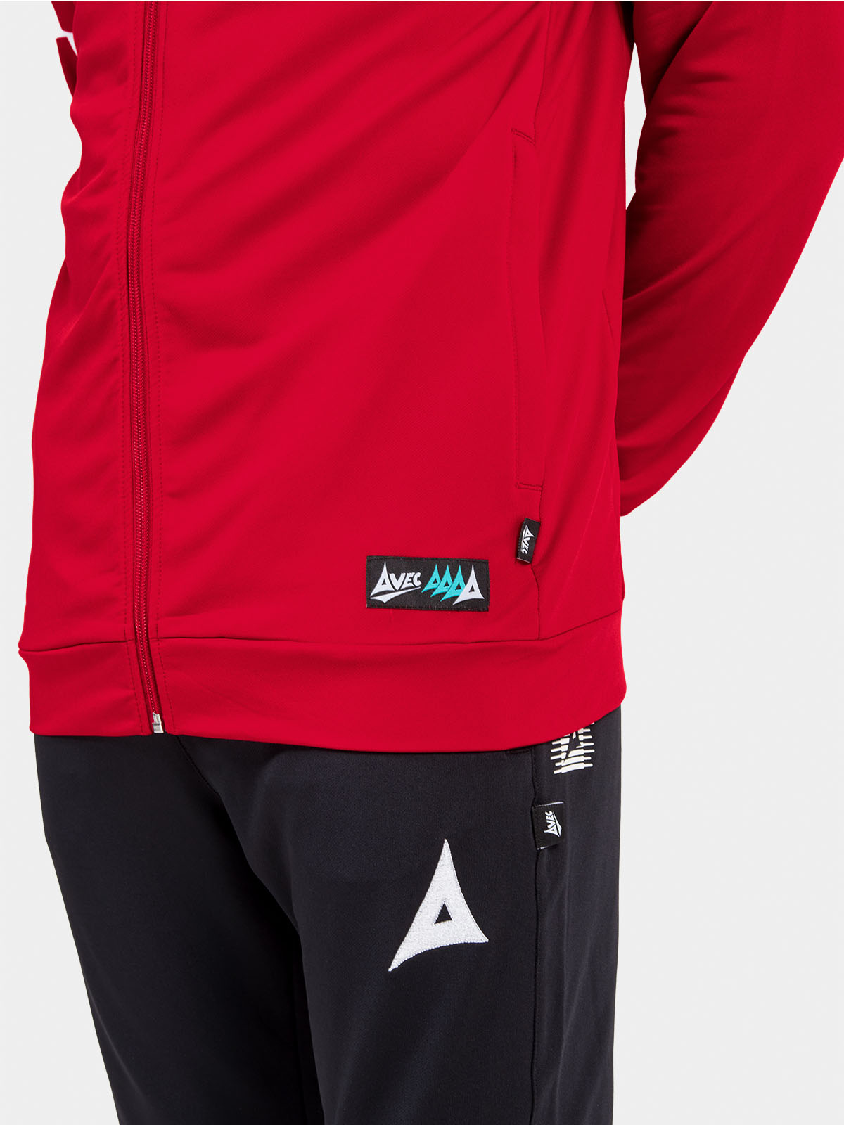 	close-up of the red hoody hem, displaying the functional side pocket and official authenticity id label.