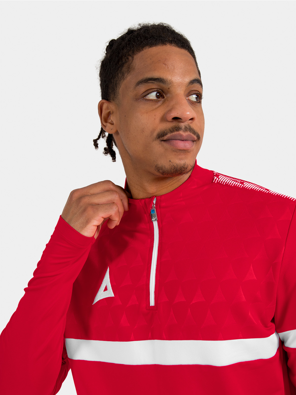 	macro shot of the red 1/4 zip fully fastened, showcasing the premium zipper and protective neck coverage.