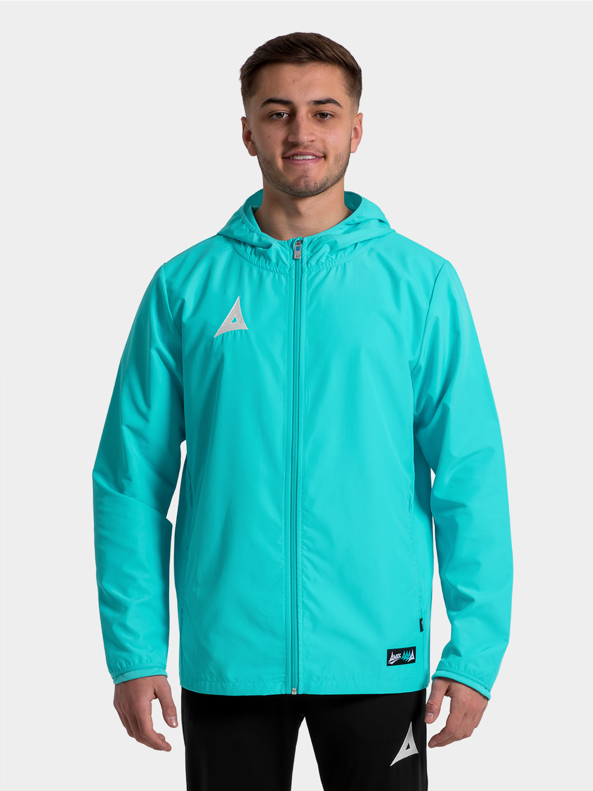 	close-up of the hyper blue focus 2 jacket on a model, highlighting the quality embroidered heritage ‘a’ logo.