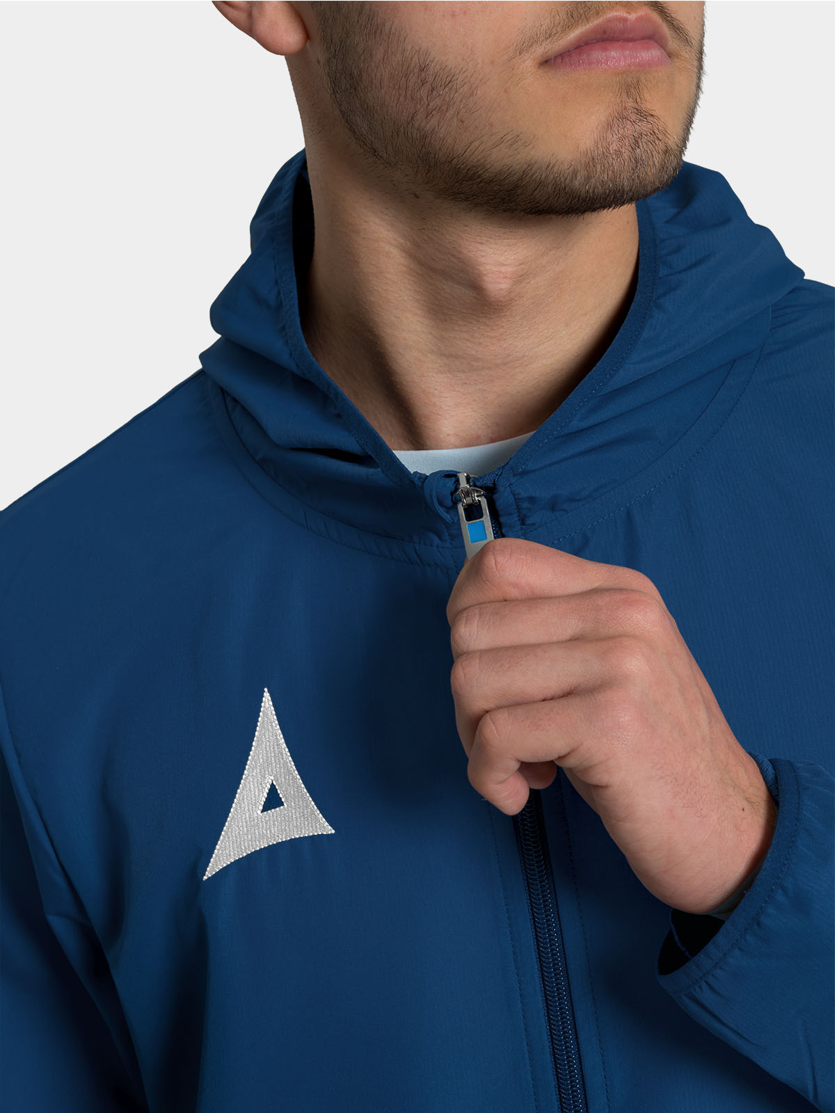 	close-up of the robust front zip on the navy focus 2 football rain jacket, ensuring a secure and warm fit.