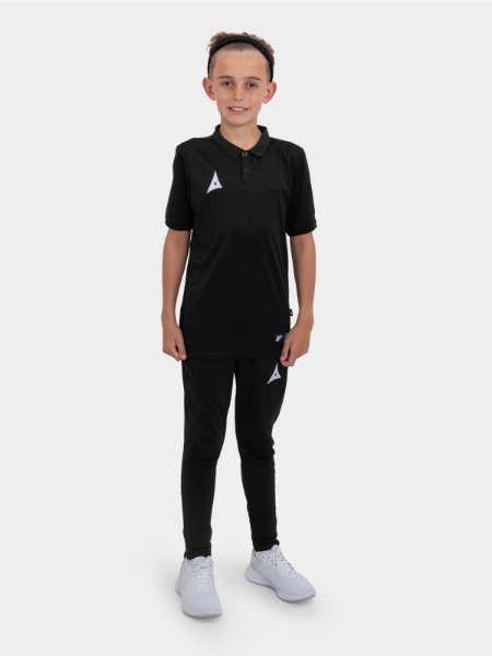 	A boy is stood wearing the Avec Focus 2 Black Tech Polo and the Avec Focus 2 Black Tech Pant ready for training