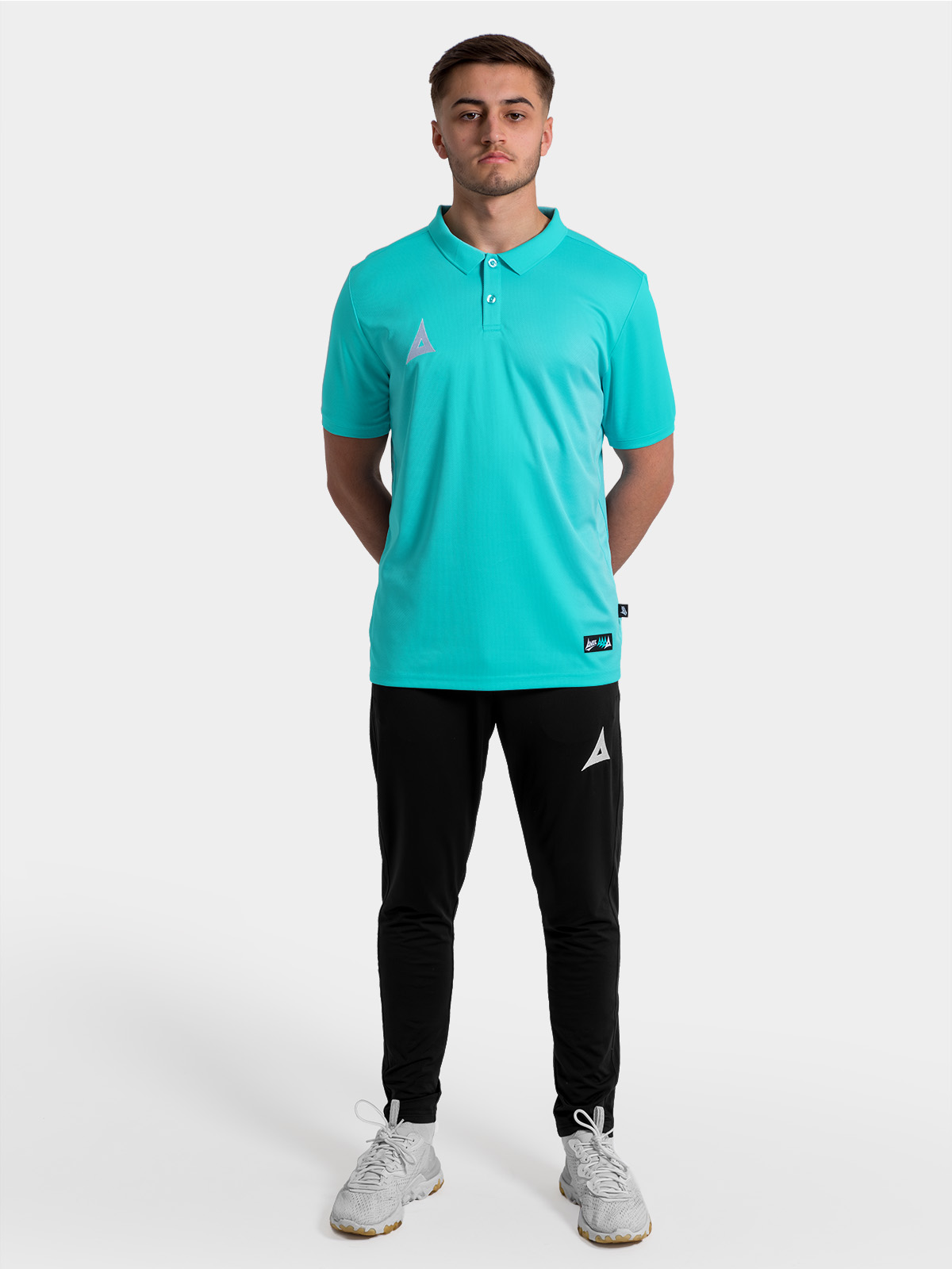 full squad travel look featuring the navy focus 2 tech polo paired with technical training trousers.