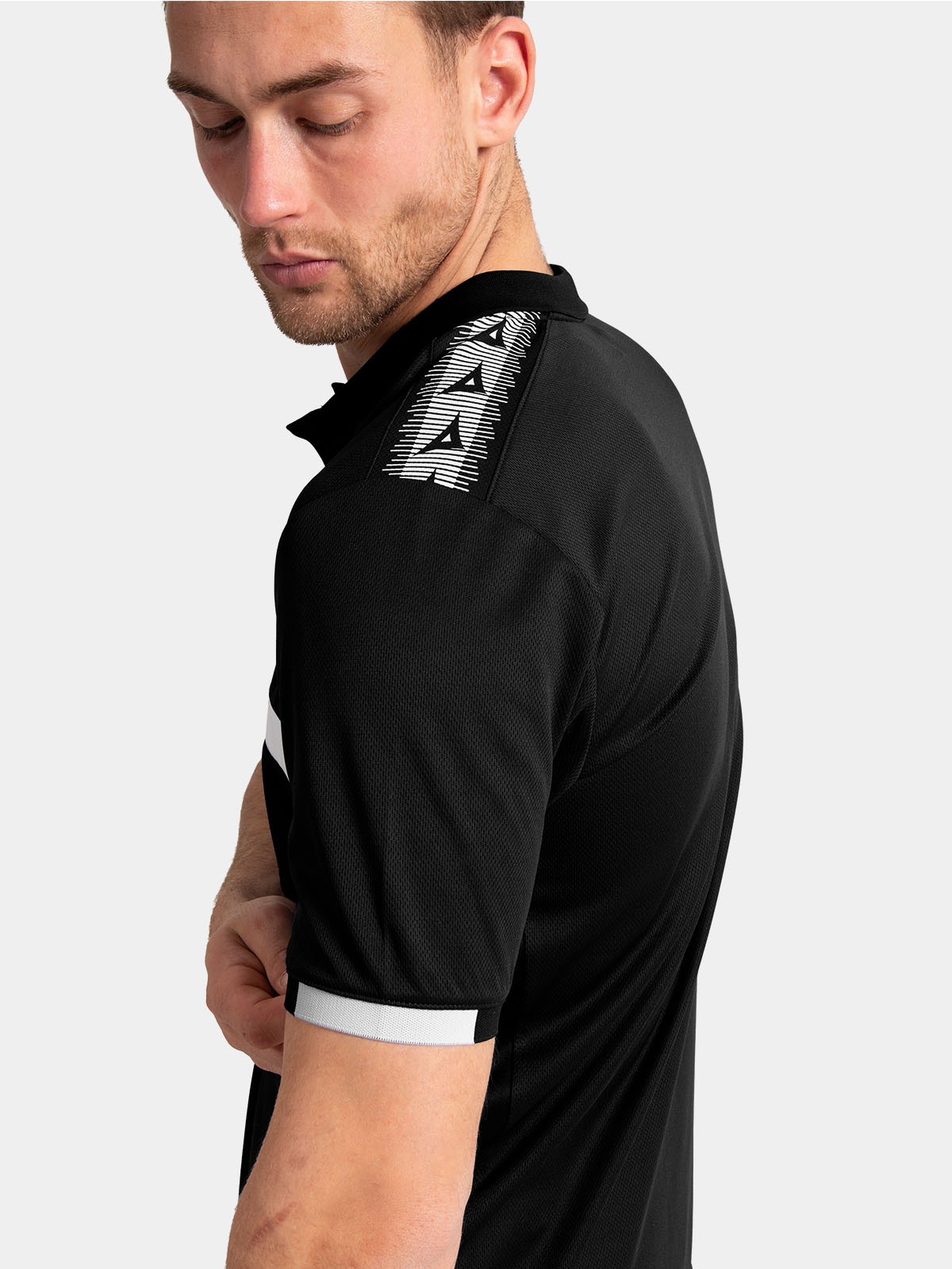 	close-up of the polo sleeve featuring the iconic heritage 'a' logo taping along the shoulder.