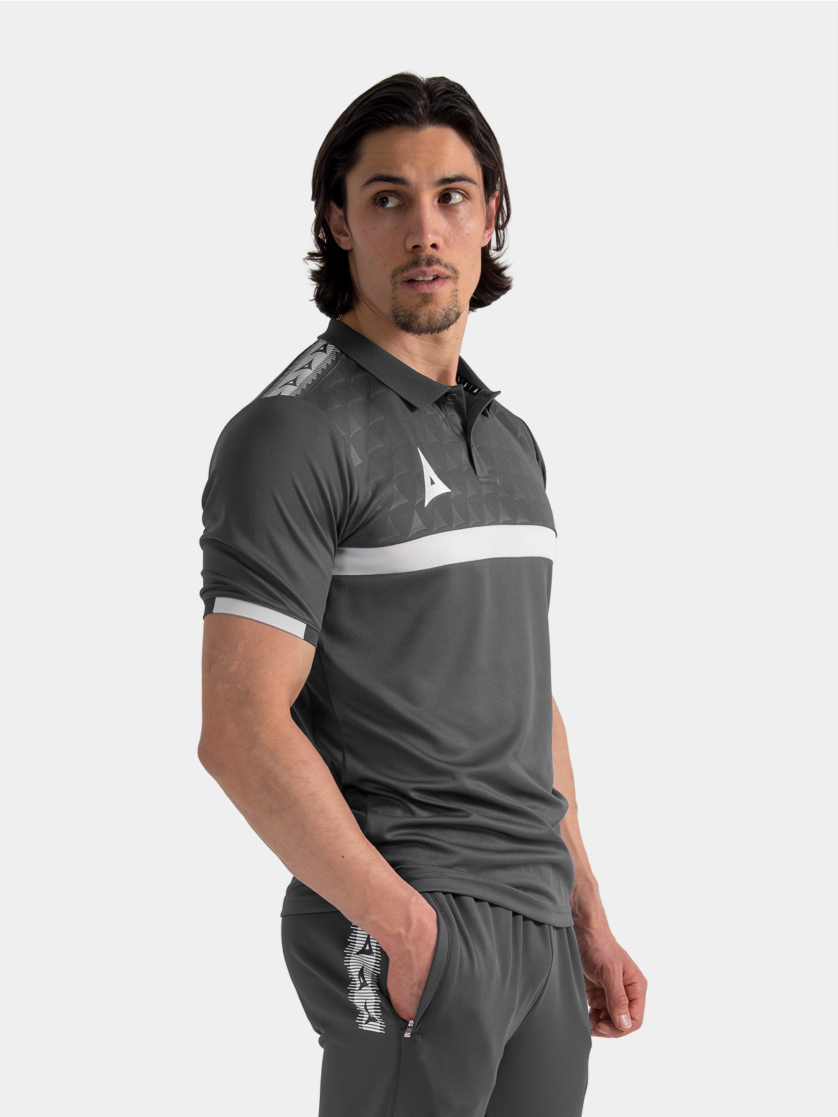 	model showcasing the anthracite pro tech polo, illustrating the modern charcoal travel aesthetic.